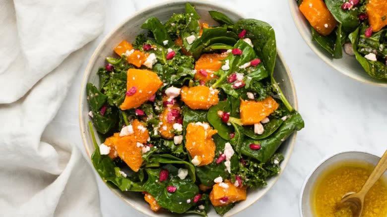 Squash pomegranate salad in rustic bowl