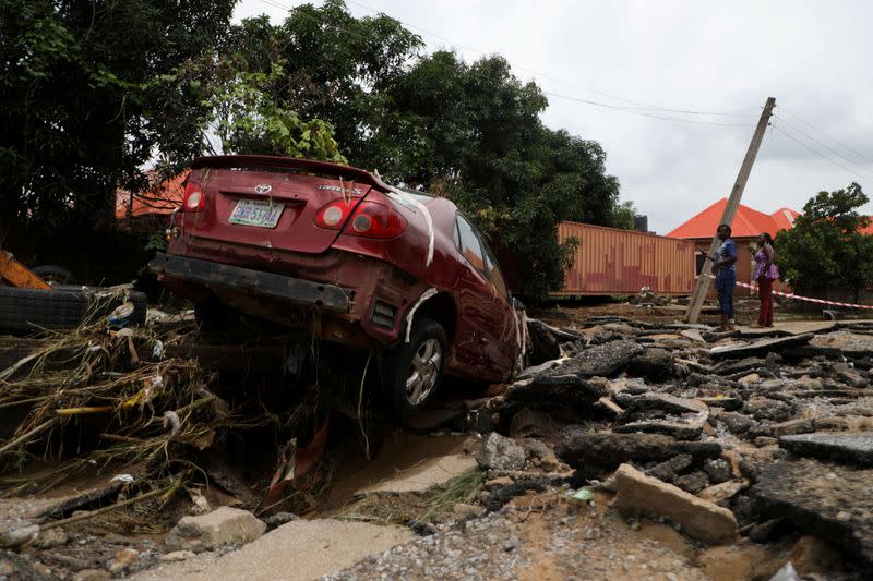 FILE PHOTO: A car washed away during the flooding which destroyed several homes at Trademore estate Abuja