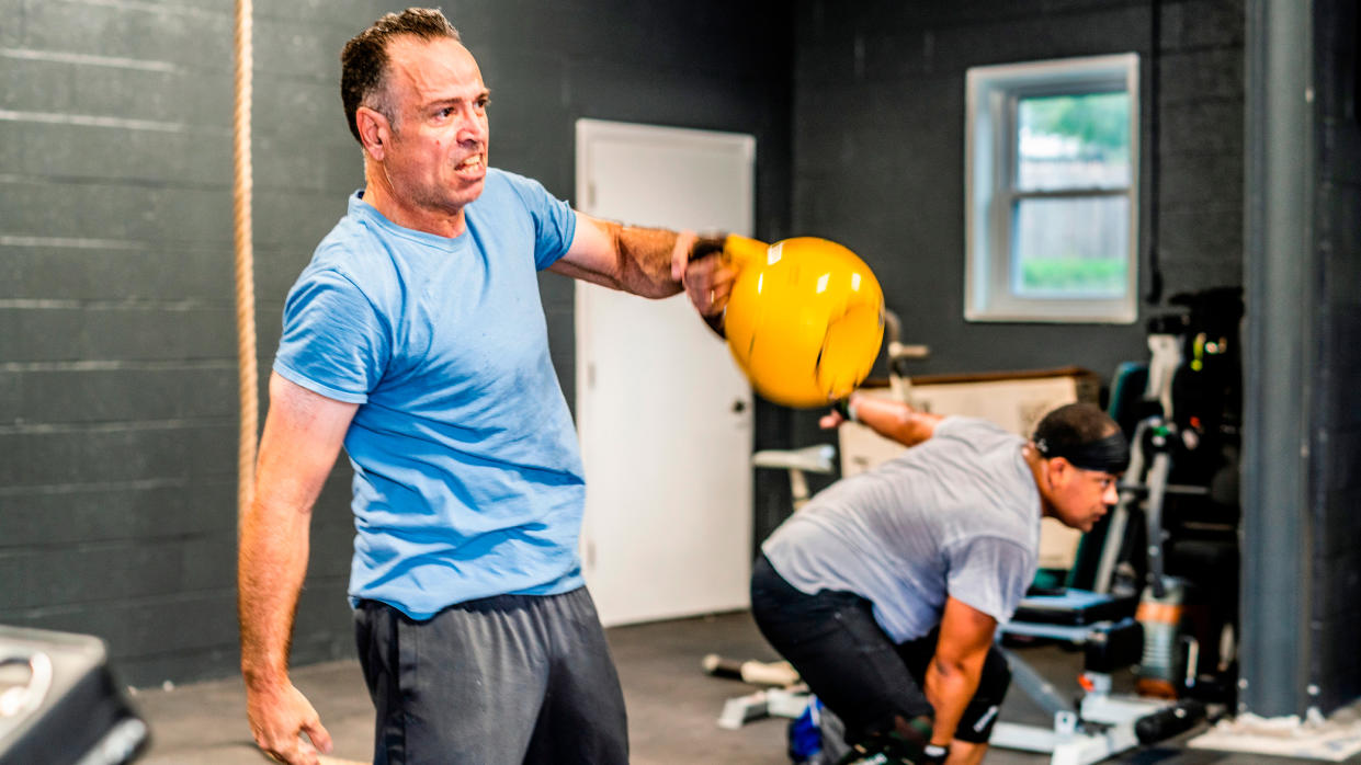  Man performing kettlebell exercise 