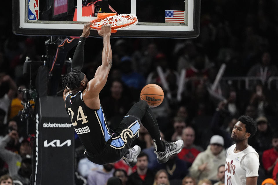 Atlanta Hawks forward Bruno Fernando (24) scores as Cleveland Cavaliers center Damian Jones (30) looks on during the second half of an NBA basketball game Wednesday, March 6, 2024, in Atlanta. (AP Photo/John Bazemore)