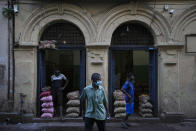 Merchants of imported food items wait to trade them at a wholesale market in Colombo, Sri Lanka, Sunday, June 26, 2022. Sri Lankans have endured months of shortages of food, fuel and other necessities due to the country's dwindling foreign exchange reserves and mounting debt, worsened by the pandemic and other longer term troubles. (AP Photo/Eranga Jayawardena)