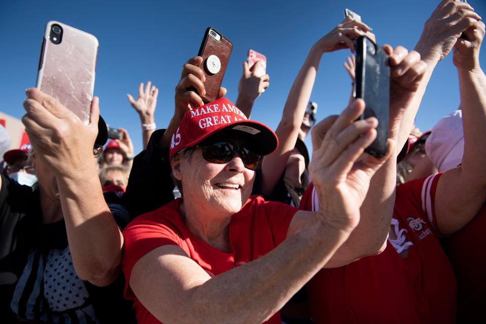 People cheer as US President Donald Trump arrives during a Make America Great Again rally at Phoenix Goodyear Airport October 28, 2020, in Goodyear, Arizona. (Photo by Brendan Smialowski / AFP) (Photo by BRENDAN SMIALOWSKI/AFP via Getty Images)