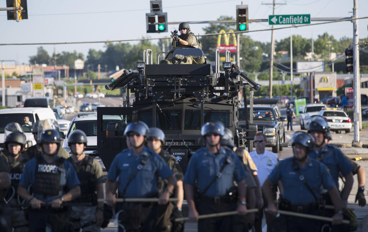 Riot police stand guard in August 2014 as demonstrators protest the shooting death of teenager Michael Brown in Ferguson, Mo. (Photo: Mario Anzuoni/Reuters)