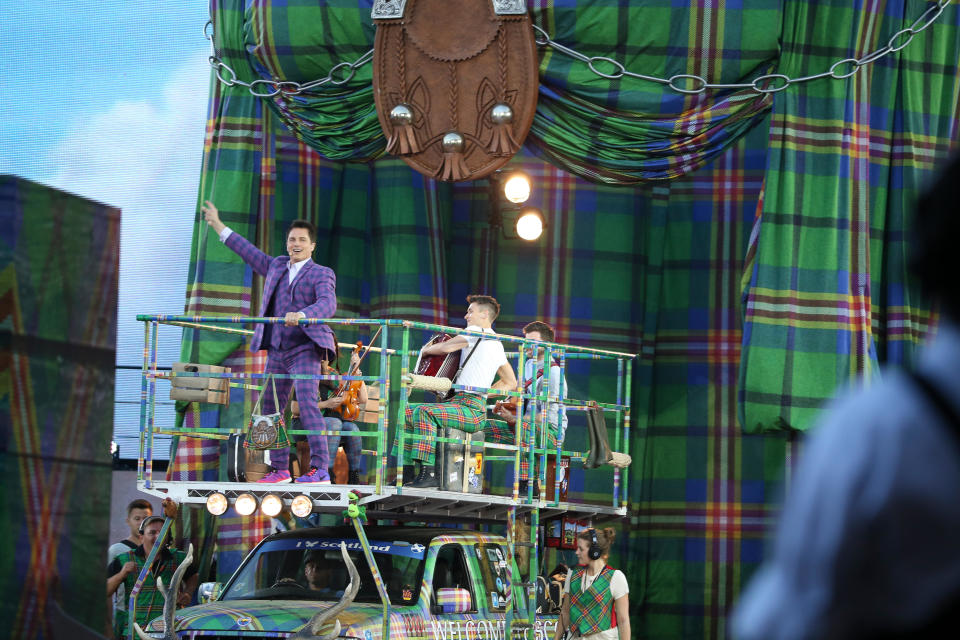 Glasgow, Scotland, UK. 23rd July, 2014. Opening ceremony of the 20th Commonwealth Games in Glasgow at Celtic Park. John Barrowman appears from under a giant kilt Credit:  ALAN OLIVER/Alamy Live News