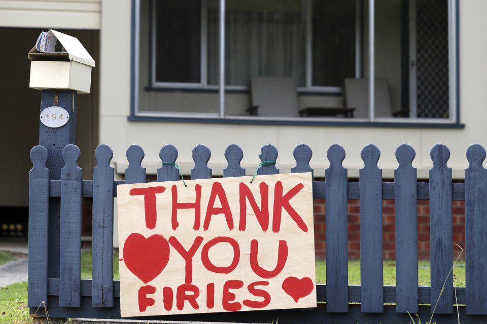 A sign is displayed near Ulludulla, Australia, Thursday, Jan. 9, 2020, thanking "firies" a colloquial term for firefighters. House after house in affected areas have hung makeshift banners offering thanks to the people they call "firies." It's a far cry from how many Australians view their leader, Prime Minister Scott Morrison, who has been widely ridiculed for his response to the disaster. (AP Photo/Rick Rycroft)