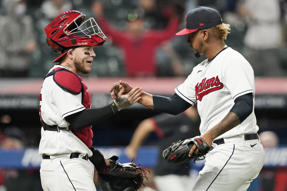 Cleveland Indians relief pitcher Emmanuel Clase, right, is congratulated by catcher Roberto Perez after the Indians defeated the Detroit Tigers 4-1 in a baseball game Friday, April 9, 2021, in Cleveland. (AP Photo/Tony Dejak)