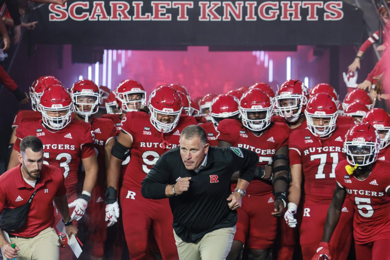 Sep 24, 2022; Piscataway, New Jersey, USA; Rutgers Scarlet Knights head coach Greg Schiano leads his team on to the field before a game against the Iowa Hawkeyes at SHI Stadium. Mandatory Credit: Vincent Carchietta-USA TODAY Sports