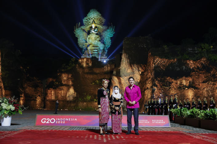 Indonesian President Joko Widodo, left, and his wife Iriana Widodo pose with Canadian Prime Minister Justin Trudeau, right, at the Welcoming Dinner during G20 Leaders' Summit, at the Garuda Wisnu Kencana Cultural Park, in Badung, Bali, Indonesia, on Tuesday Nov. 15, 2022. (Willy Kurniawan/Pool Photo via AP)