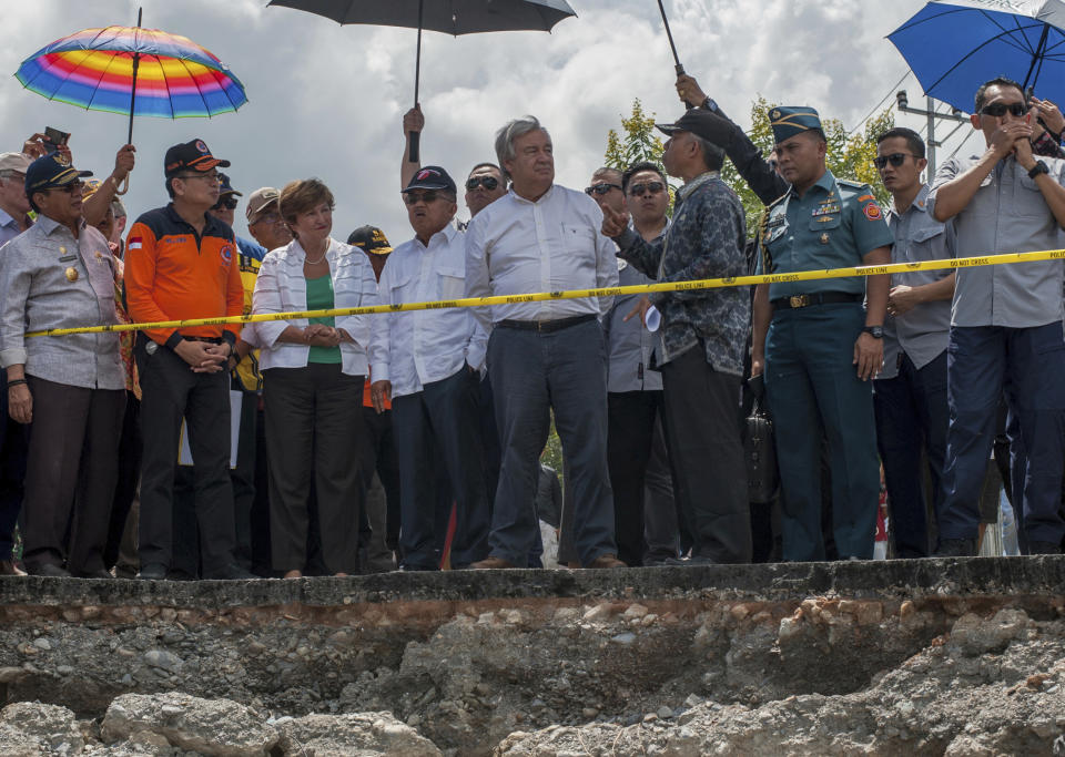 U.N. Secretary General Antonio Guterres, center right, accompanied by Indonesian Vice President Jusuf Kalla, center left, survey the damage suffered by earthquake-devastated neighborhood of Balaroa in Palu, Central Sulawesi, Indonesia, Friday, Oct. 12, 2018. (AP Photo/Fauzy Chaniago)