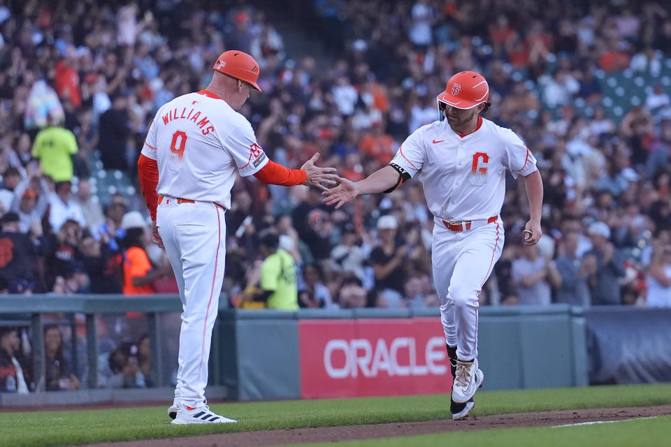 The Giants' Brett Wisely, right, is congratulated by third-base coach Matt Williams after hitting a home run in the team's City Connect uniform on June 11, 2024. (AP Photo/Jeff Chiu)