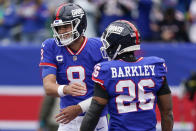 New York Giants quarterback Daniel Jones (8) celebrates with running back Saquon Barkley (26) after scoring a touchdown against the Chicago Bears during the first quarter of an NFL football game, Sunday, Oct. 2, 2022, in East Rutherford, N.J. (AP Photo/Seth Wenig)