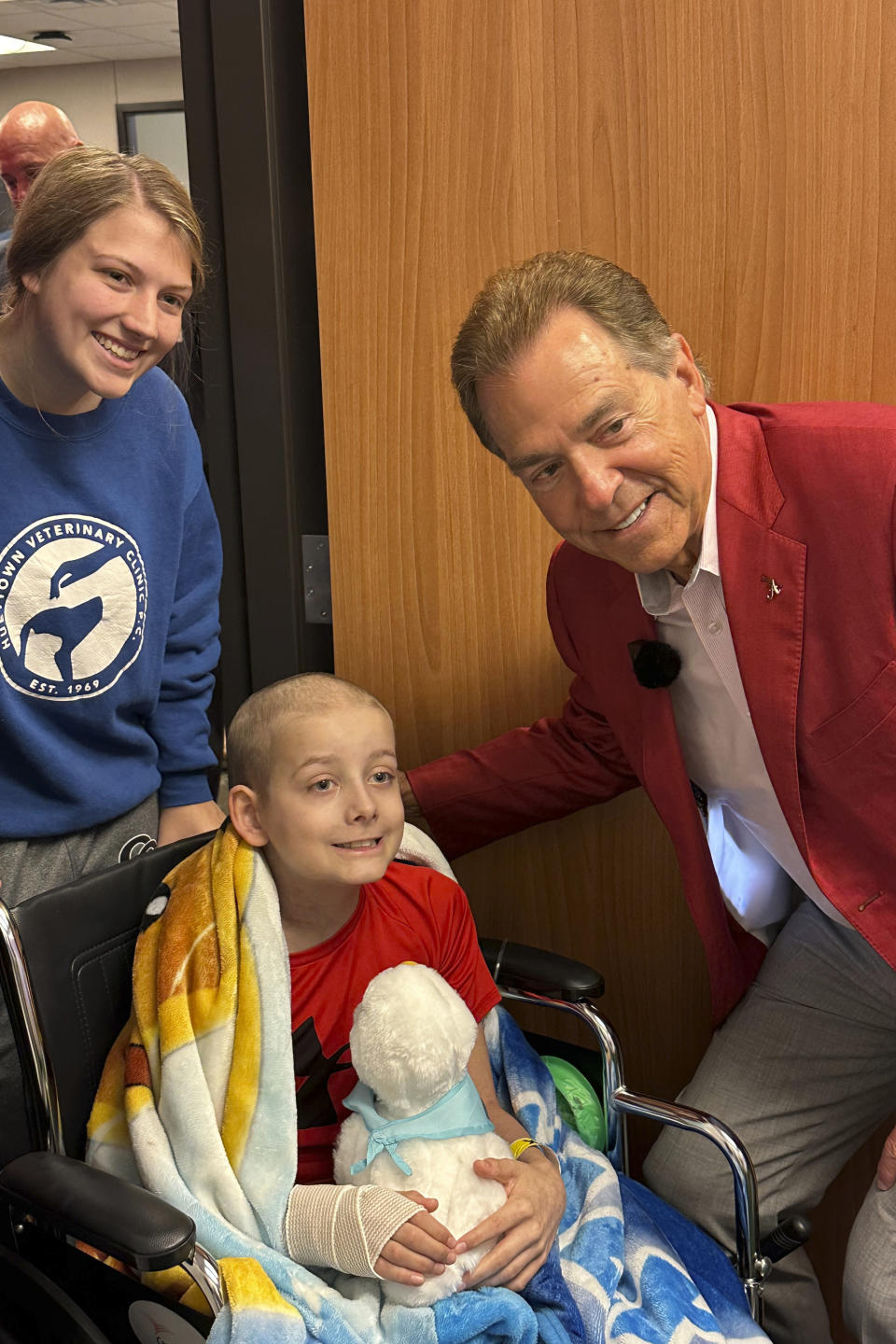 Alabama NCAA college football head coach Nick Saban poses with 11-year-old cancer patient Kameron Swann and sister Brianna during an event at Children's Hospital in Birmingham, Alabama on Tuesday, June 6, 2023. (AP Photo/John Zenor)