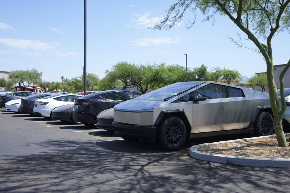 A variety of Tesla vehicles are stored at a shopping mall parking lot of a closed movie theater Friday, June 21, 2024, in Scottsdale, Ariz. (AP Photo/Ross D. Franklin)