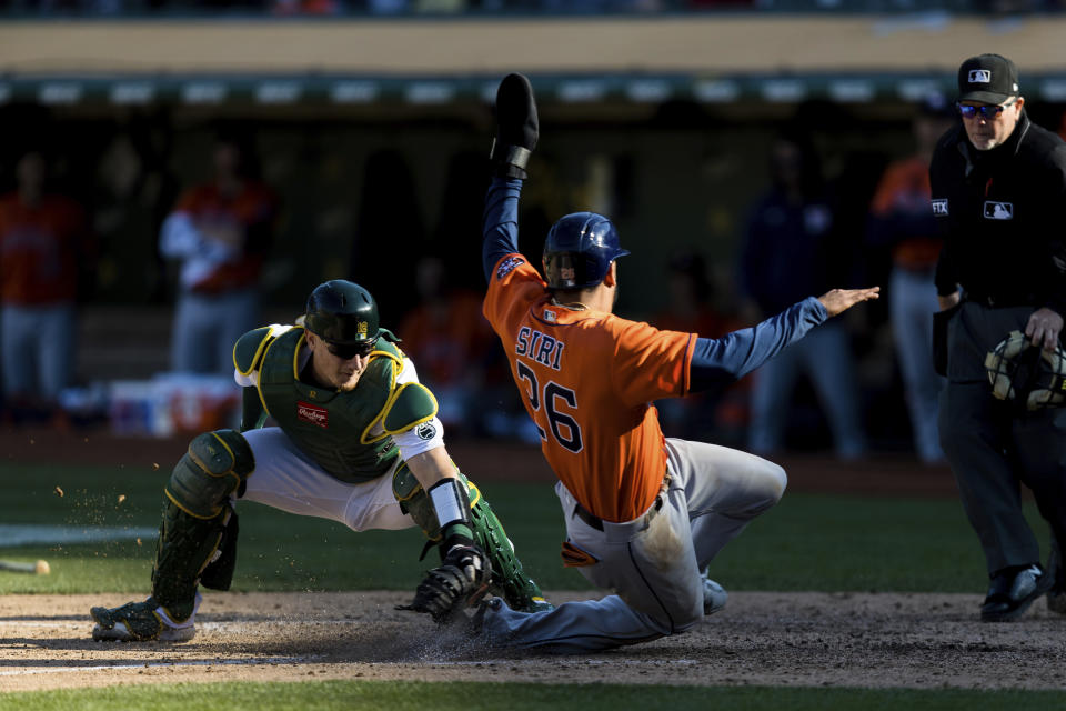 Oakland Athletics catcher Sean Murphy, left, tags out Houston Astros' Jose Siri (26) in the ninth inning of a baseball game in Oakland, Calif., Sunday, Sept. 26, 2021. (AP Photo/John Hefti)