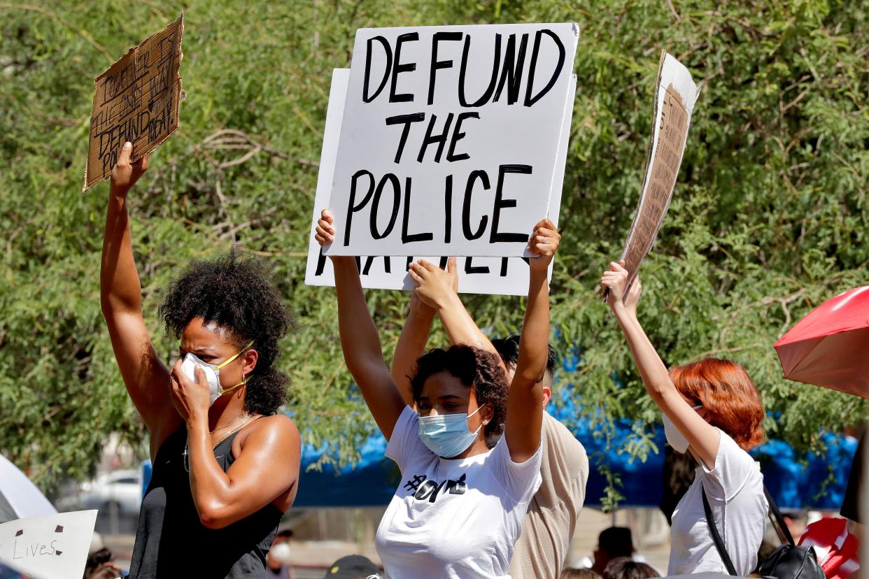 Protesters rally on June 3 in Phoenix demanding the city council defund the police department. The protest, like others nationwide, was sparked by the death of George Floyd, a Black man who was killed by Minneapolis police on May 25. (ASSOCIATED PRESS)