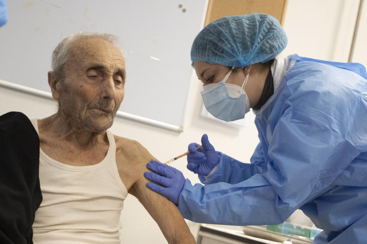 Luigi Monte receives the COVID-19 vaccine at the Don Orione home in Rome, Italy on Saturday, Jan. 2, 2021. The elderly at the Don Orione home received the COVID-19 vaccine Saturday in Rome, in a second round of vaccinations following those for health workers last week.