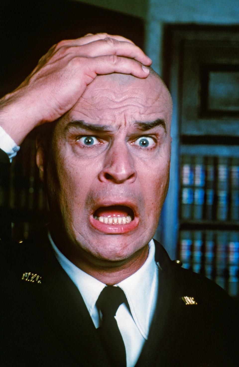 Richard Moll with hand on head