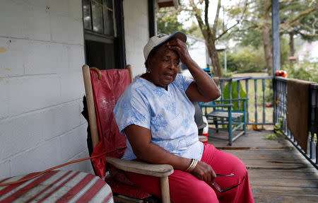 Minnie Williams takes a break while preparing her home to reconnect the electricity after flooding due to Hurricane Florence receded in Fair Bluff, North Carolina, U.S. September 29, 2018. REUTERS/Randall Hill