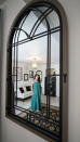 Heather Bise, owner of The House of Bise Bespoke, is reflected in a mirror in the "Art" bedroom, Monday, July 19, 2021, in Cleveland. Small businesses in the U.S. that depend on tourism and vacationers say business is bouncing back, as people re-book postponed trips and take advantage of loosening restrictions, a positive sign for the businesses that have struggled for more than a year. Bise started in 2019 and catered to international tourists, attracting guests from New Zealand, Botswana, Eastern Europe and elsewhere. (AP Photo/Tony Dejak)