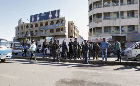 Iraqi security forces gather at the site of a bomb attack in Baghdad's Bab Sharji district, March 29, 2016. REUTERS/Khalid al Mousily