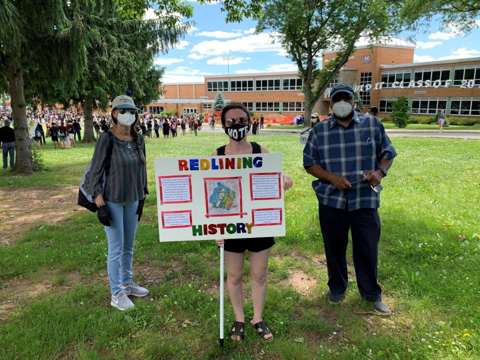 Courtney Cooperman attended a Black Lives Matter rally in Millburn, N.J., in June with a poster showing a history of redlining in Essex County.