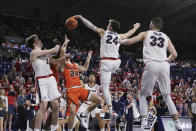 Gonzaga forward Corey Kispert, second from the right, blocks a shot by Pacific guard Broc Finstuen, second from the left, in front of teammates Drew Timme, left, and Killian Tillie during the second half of an NCAA college basketball game in Spokane, Wash., Saturday, Jan. 25, 2020. Gonzaga won 92-59. (AP Photo/Young Kwak)