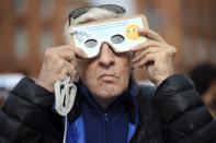 <p>A man uses protective glasses to watch a solar eclipse on March 20, 2015 in Toulouse, France. (Photo: Remy Gabalda/AFP/Getty Images) </p>