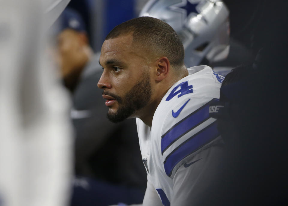 Dallas Cowboys quarterback Dak Prescott sits on the bench late in the second half of the team's NFL football game against the Green Bay Packers in Arlington, Texas, Sunday, Oct. 6, 2019. (AP Photo/Ron Jenkins)