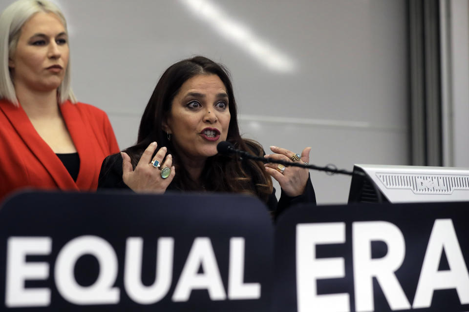 Kamala Lopez, right, president of Equal Means Equal, faces reporters as Natalie White, left, vice president of the organization, looks on during a news conference, Tuesday, Jan. 7, 2020, in Boston, held to address issues about a lawsuit filed in U.S. District Court. Supporters of the Equal Rights Amendment filed the federal lawsuit in Massachusetts aimed at paving the way for adoption of the long-delayed constitutional amendment. (AP Photo/Steven Senne)