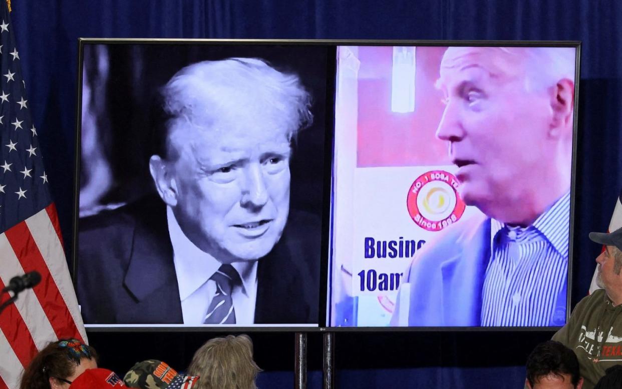 Pictures of the two men on a screen during a campaign rally for Donald Trump in Green Bay, Wisconsin