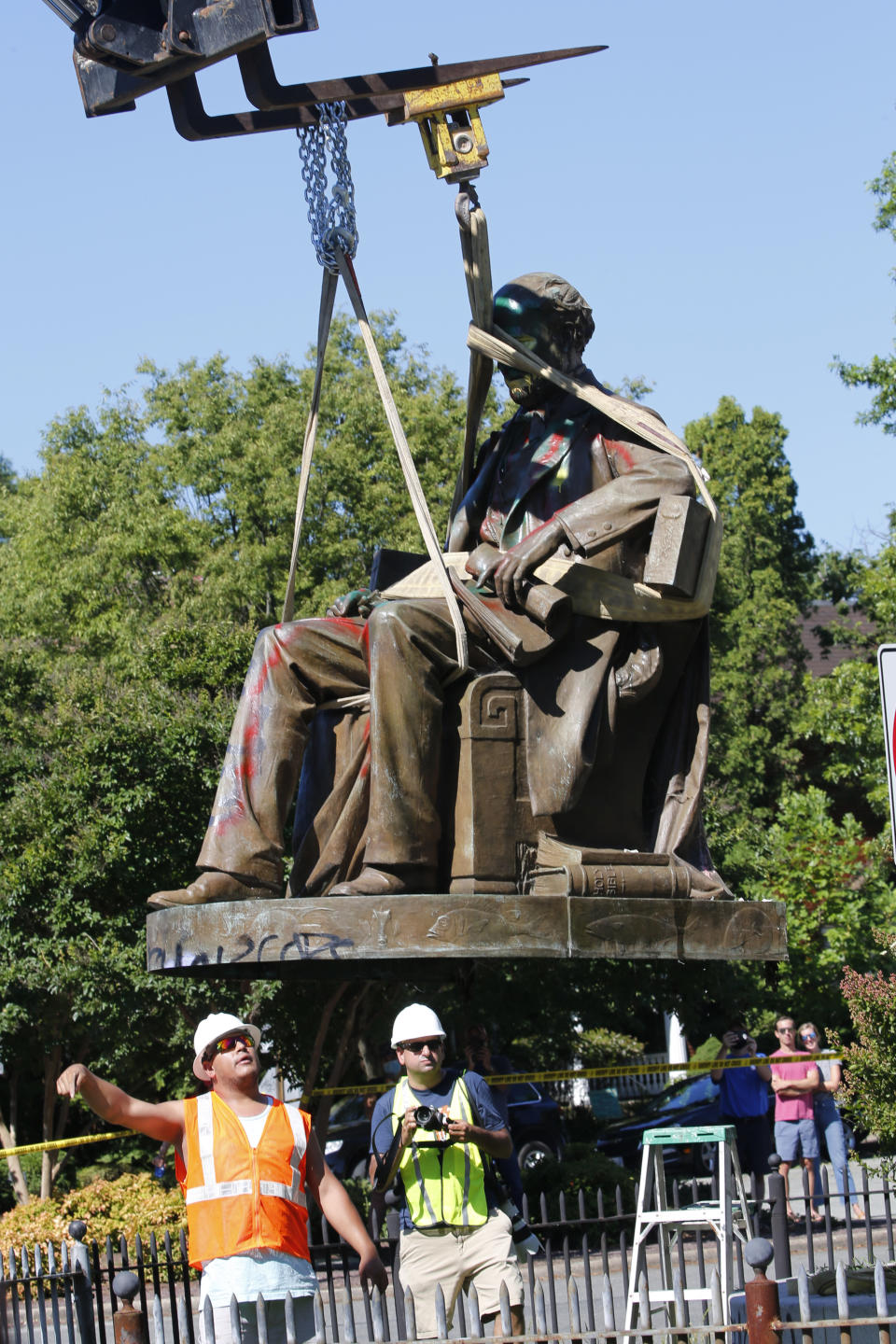 Workers remove the statue of Confederate Naval officer Matthew Fontaine Maury on Monument Avenue, Thursday July 2, 2020, in Richmond, Va. Maury was better known for his work in oceanography and other sciences before the Civil War. His statue is the second removed since a new state law was enacted on July first. (AP Photo/Steve Helber)