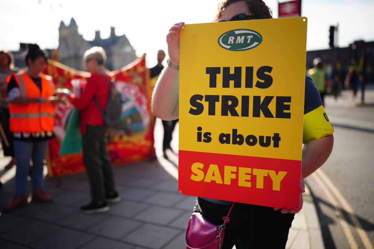 Members of the Rail, Maritime and Transport union begin their nationwide strike in Bristol, England, Tuesday June 21, 2022. Tens of thousands of railway workers walked off the job in Britain on Tuesday, bringing services grinding to a halt in the country’s biggest transit strike in three decades. (Ben Birchall/PA via AP)