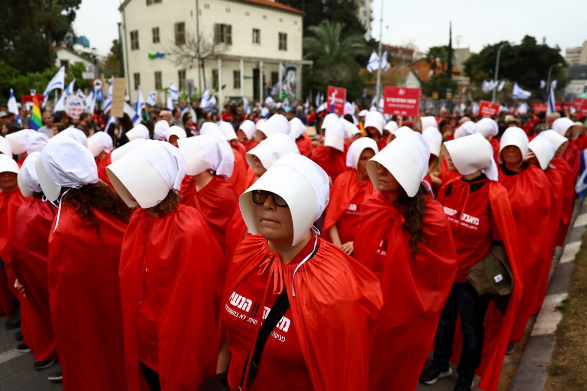 Demonstrators dressed as handmaidens from ‘The Handmaid’s Tale’ take part in protests in Israel on Thursday (REUTERS)