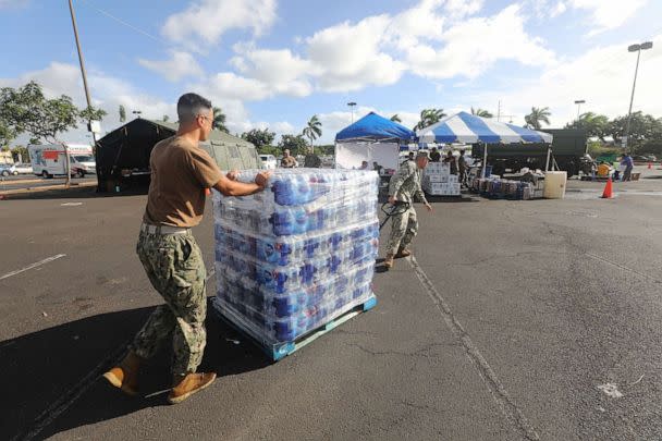 PHOTO: In this Dec. 9, 2021, file photo, Sailors and Marines assigned to various commands hand out fresh water at the Joint Base Pearl Harbor-Hickam (JBPHH) Navy Exchange Mall parking lot in Honolulu. (Chief Mass Communication Specialist Joseph M. Buliavac/U.S. Navy)