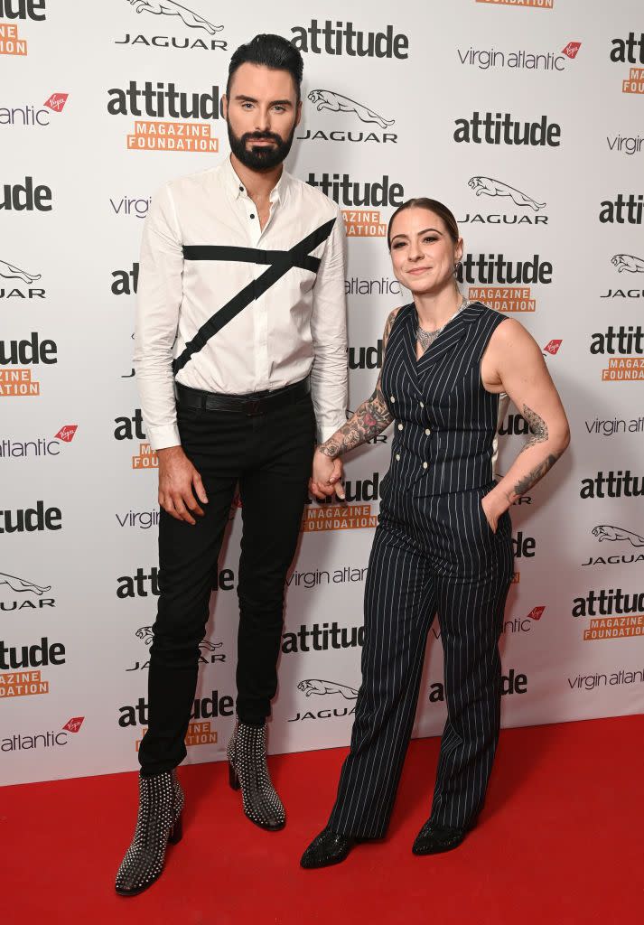 rylan clark neal and lucy spraggan attend the virgin atlantic attitude awards, holding hands on the red carpet
