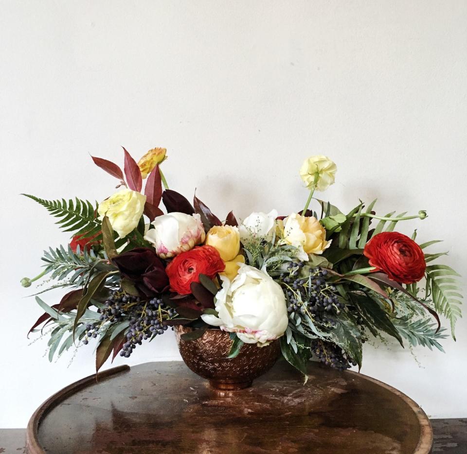 <p>Energize your winter decor by sprinkling traditional reds and greens with citrus-inspired yellow and orange hues. This bright bouquet brings a unique color palette to an all-white table setting.</p><p><em>Via </em><a href="http://www.bostonpollen.com/" rel="nofollow noopener" target="_blank" data-ylk="slk:Pollen;elm:context_link;itc:0;sec:content-canvas" class="link "><em>Pollen</em></a></p>