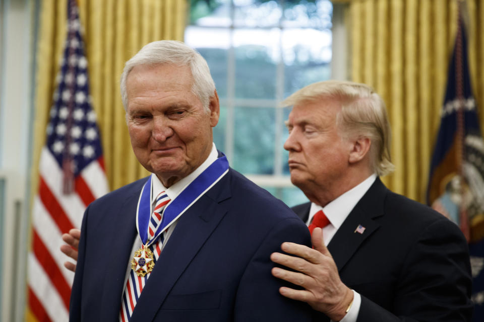 President Donald Trump, right, presents the Presidential Medal of Freedom to former NBA basketball player and general manager Jerry West, in the Oval Office of the White House, Thursday, Sept. 5, 2019, in Washington. (AP Photo/Alex Brandon)