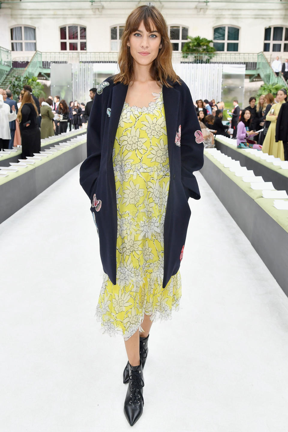 <p><strong>1 October</strong> Alexa Chung looked pretty in a lemon and white slip dress which she wore under a navy coat. </p>