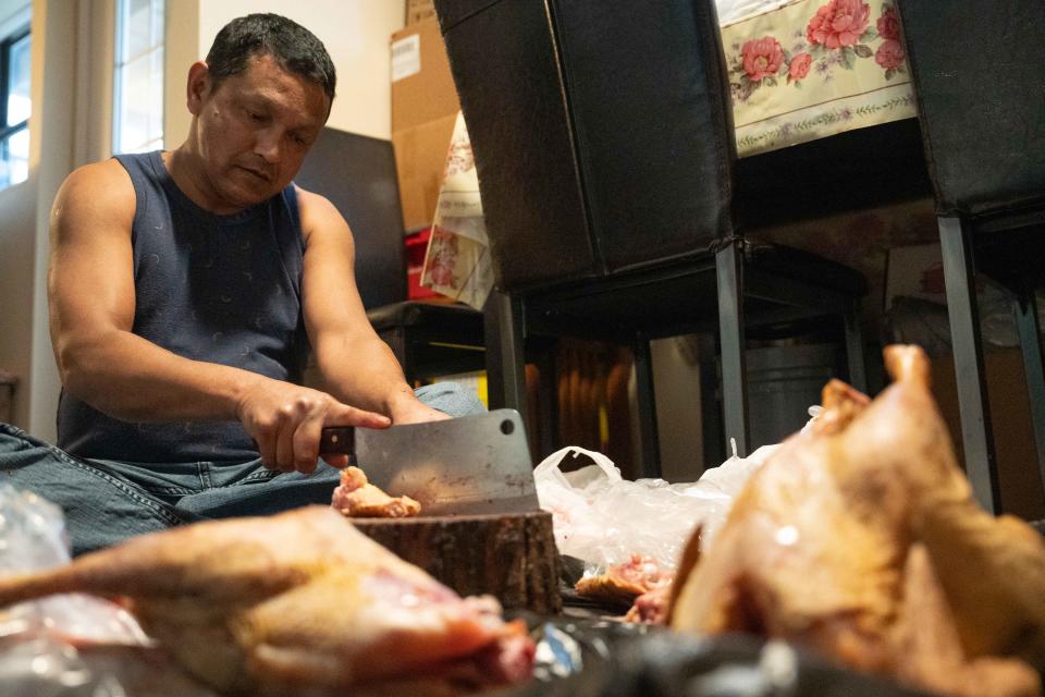 Nov 11, 2023; Columbus, Ohio, USA;
Mani Sanyasi hands cuts chicken for Tihar dinner on Saturday, Nov. 11, 2023.