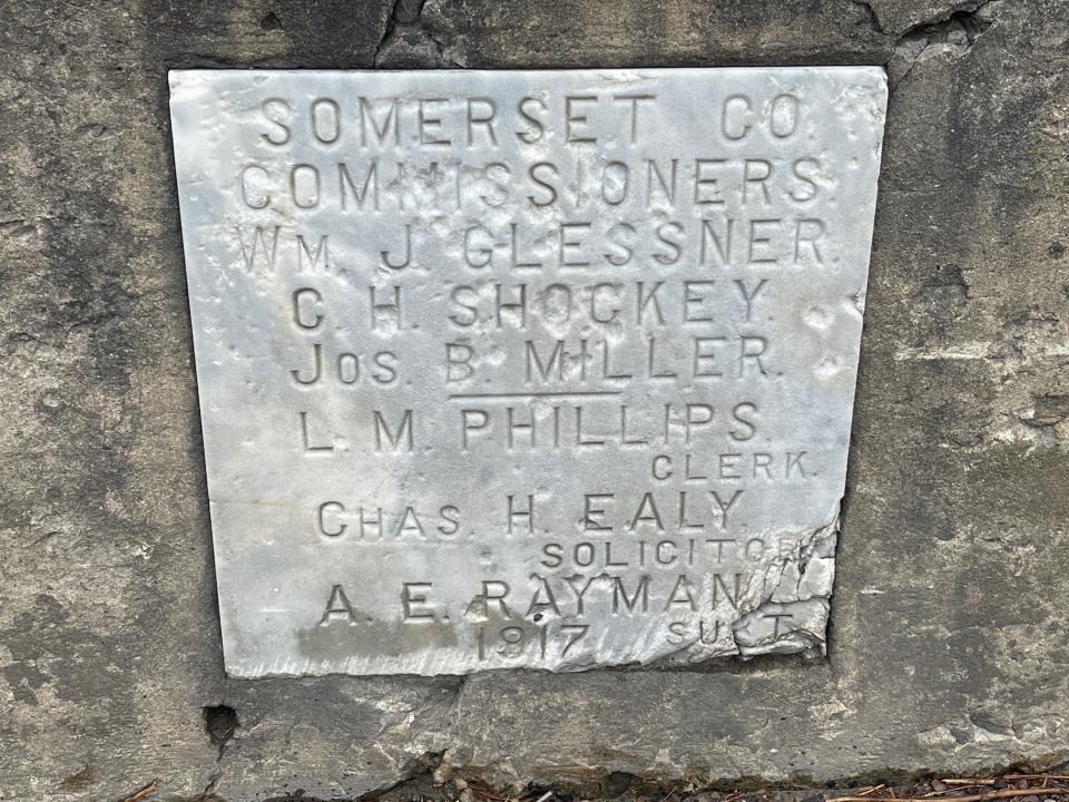 A sign on the Black Hill Road bridge, which crosses Beaver Dam Creek, shows who the county commissioners were in 1917 when the bridge was built.