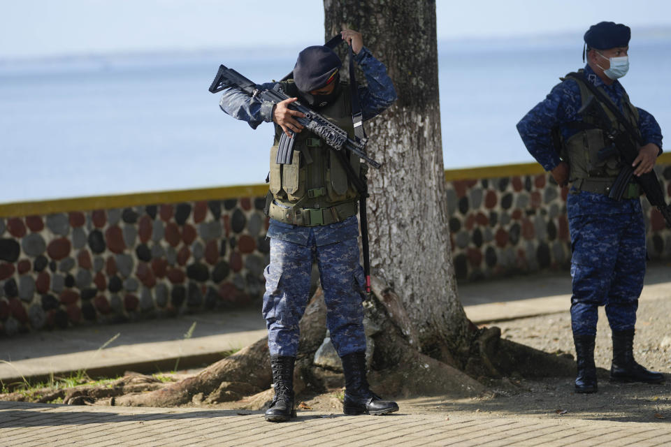 Soldiers patrol in El Estor, the northern coastal province of Izabal, Guatemala, Monday, Oct. 25, 2021. The Guatemalan government has declared a month-long, dawn-to-dusk curfew and banned pubic gatherings following protests against a nickel mining project. (AP Photo/Moises Castillo)