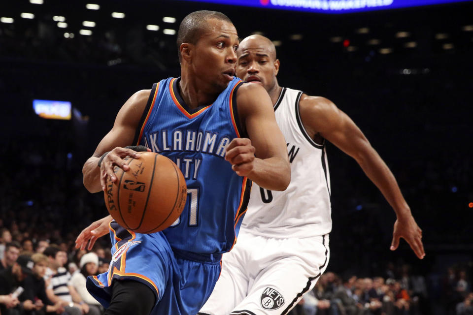 FILE - Oklahoma City Thunder guard Sebastian Telfair (31) dribbles past Brooklyn Nets guard Jarrett Jack (0) in the first half of an NBA basketball game in New York, in this Monday, Nov. 3, 2014, file photo. Eighteen former NBA players, including Telfair, have been charged with defrauding the league’s health and welfare benefit plan out of about $4 million, according to an indictment Thursday, Oct. 7, 2021. (AP Photo/John Minchillo, File)