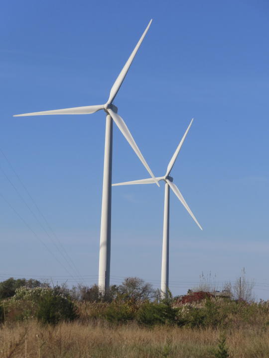 Land-based wind turbines spin in Atlantic City N.J. on Nov. 3, 2023. On Friday, Nov. 17, New Jersey utility regulators voted to seek bids for an energy transmission project to help bring power from ocean-based turbines to the onshore electrical grid. (AP Photo/Wayne Parry)