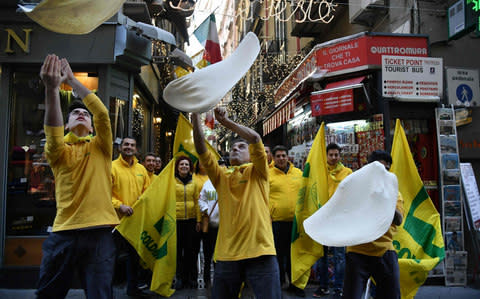 Pizzaiuolos celebrate the margherita pizza being given world heritage status by Unesco - Credit: AFP/ TIZIANA FABI