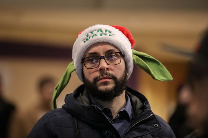 A man wears a Star Wars Yoda Santa hat during the "Star Wars: The Rise of Skywalker" movie opening night fan event in New York City