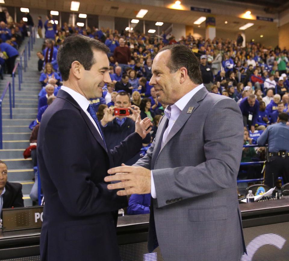 Delaware coaches present (left, Martin Ingelsby) and past (Mike Brey) greet each other before the start of the Blue Hens matchup against Notre Dame at the Bob Carpenter Center in 2017.