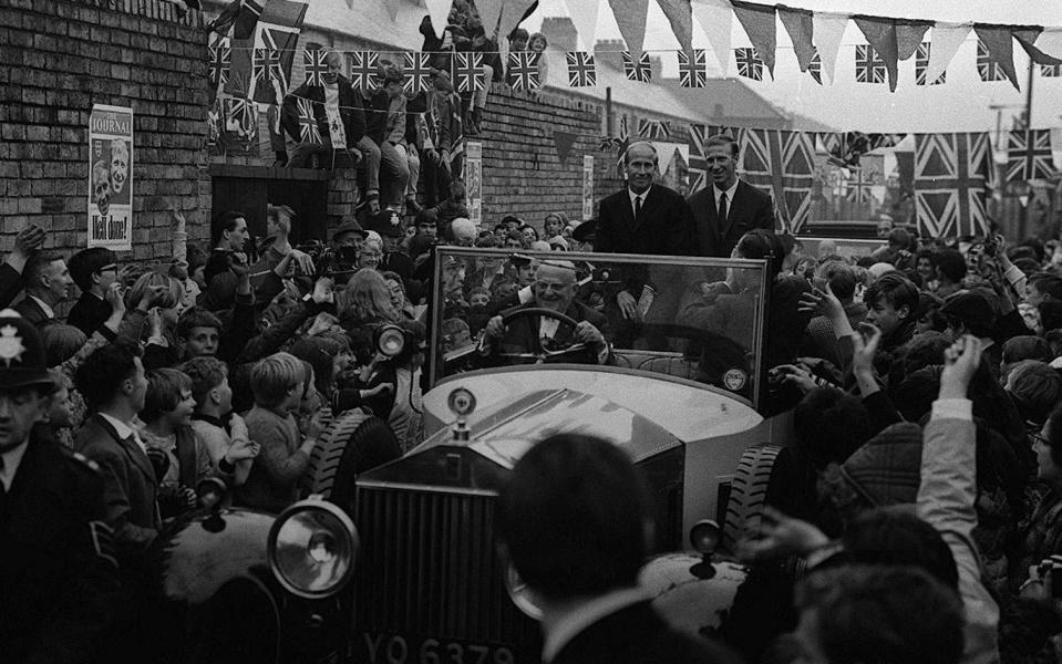 Jack and Bobby Charlton are mobbed by the crowds after leaving their mother's home