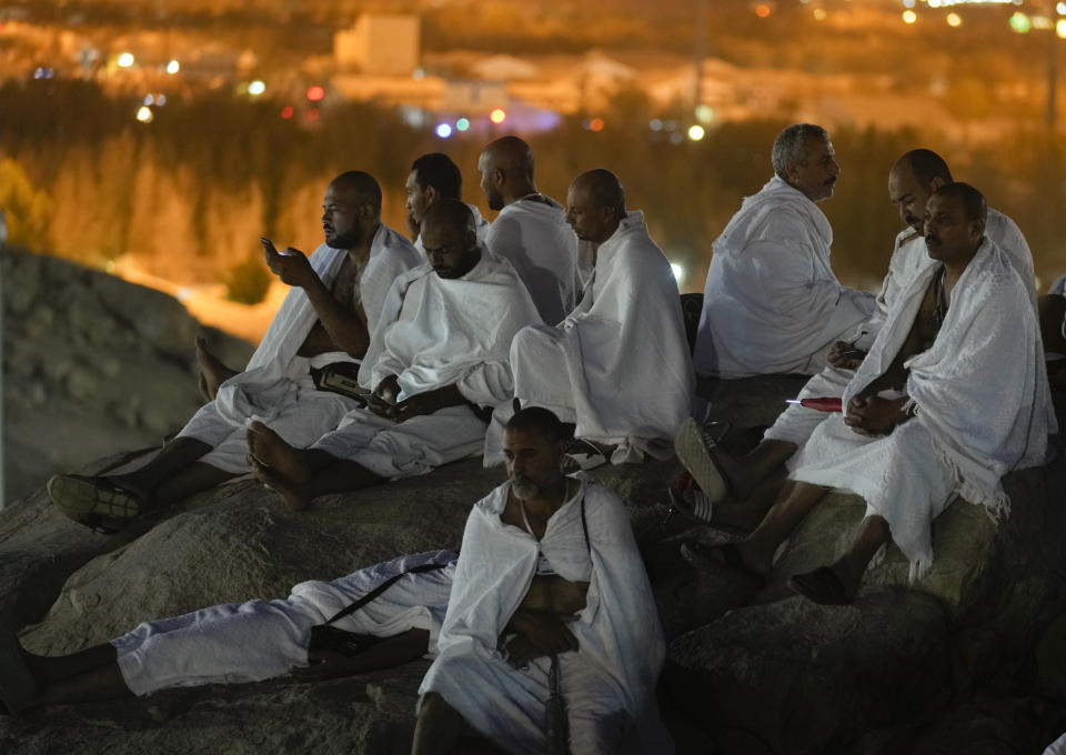 Muslim pilgrims pray on the rocky hill known as the Mountain of Mercy, on the Plain of Arafat, during the annual hajj pilgrimage, near the holy city of Mecca, Saudi Arabia, Friday, July 8, 2022. One million pilgrims from across the globe amassed on Thursday in the holy city of Mecca in Saudi Arabia to perform the initial rites of the hajj, marking the largest Islamic pilgrimage since the coronavirus pandemic upended the annual event — a key pillar of Islam. (AP Photo/Amr Nabil)