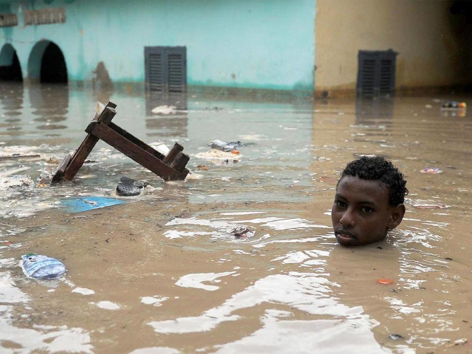 A young in deep floodwater in Mogadishu (AFP)