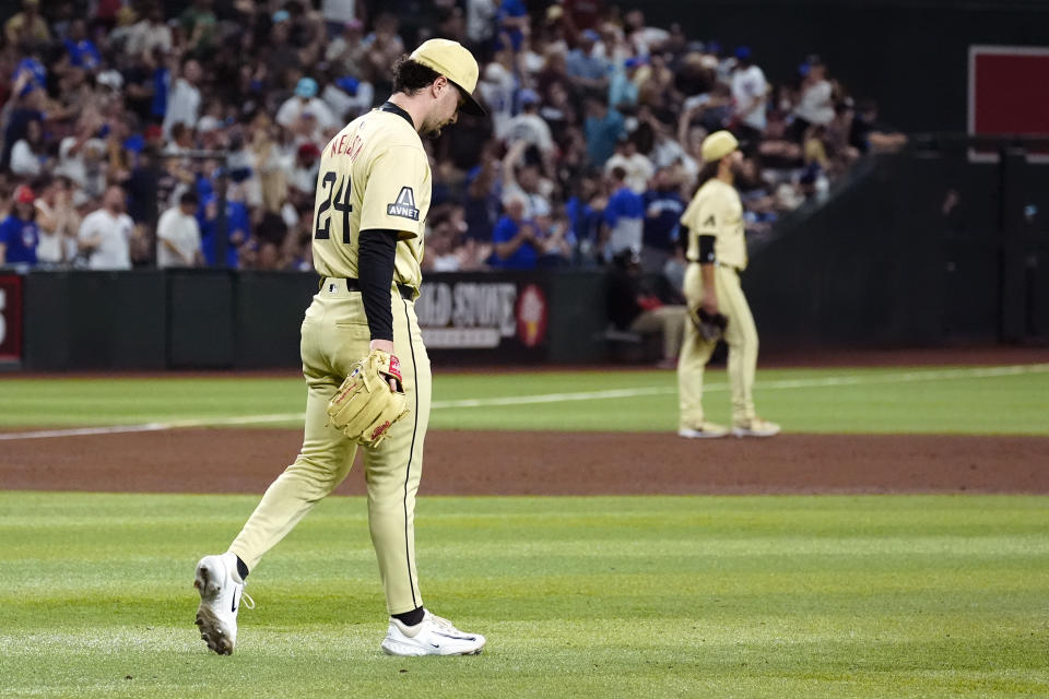 Arizona Diamondbacks pitcher Kyle Nelson pacess on the field after giving up a grand slam to Chicago Cubs' Ian Happ during the seventh inning of a baseball game Tuesday, April 16, 2024, in Phoenix. (AP Photo/Ross D. Franklin)